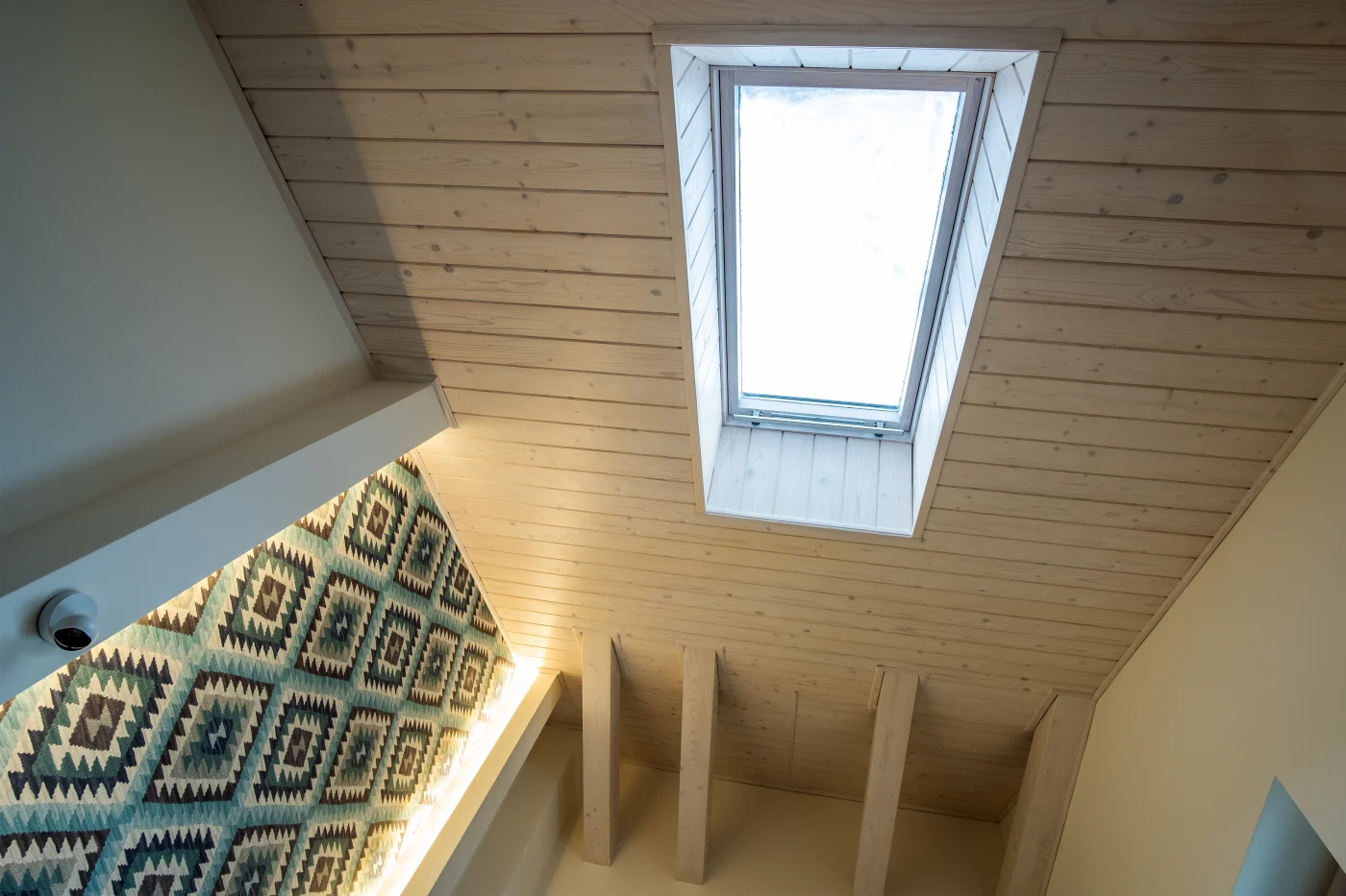 Wooden Ceiling In A Contemporary Mansard Room With Attic Window